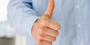 Hand gesturing thumbs-up
